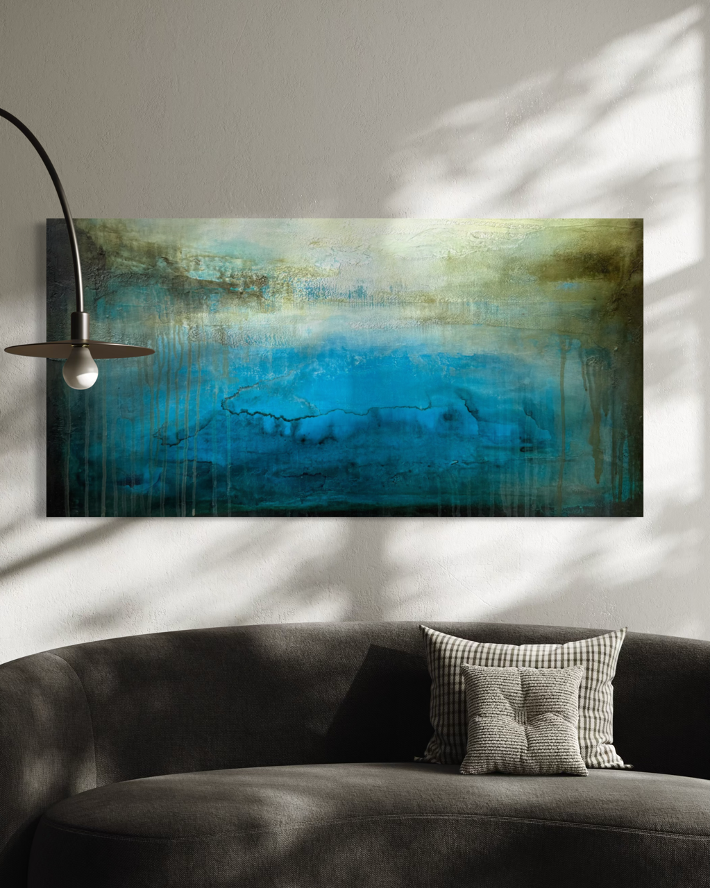 Ancient Water Horizon canvas print shown unframed over a gray modern sofa with sunlight