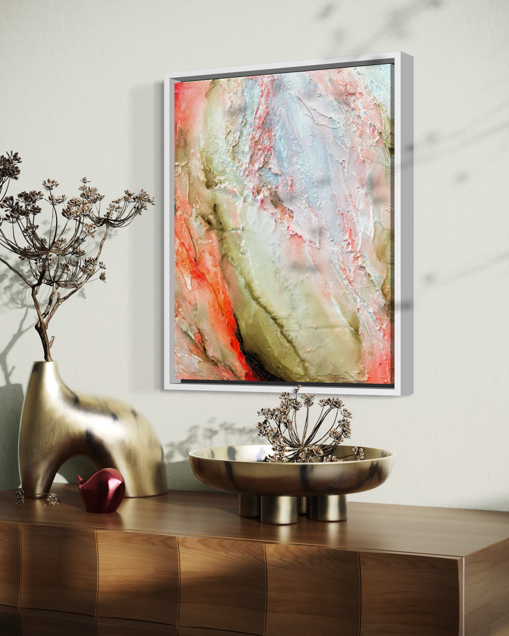 Becoming Bloom is heavily textured abstract painting in a white wood frame in a modern living room