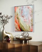 Becoming Bloom is heavily textured abstract painting in a white wood frame in a modern living room