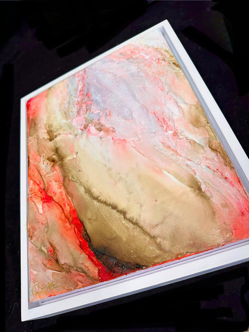 Becoming Bloom is heavily textured abstract painting in a white wood frame shown up close