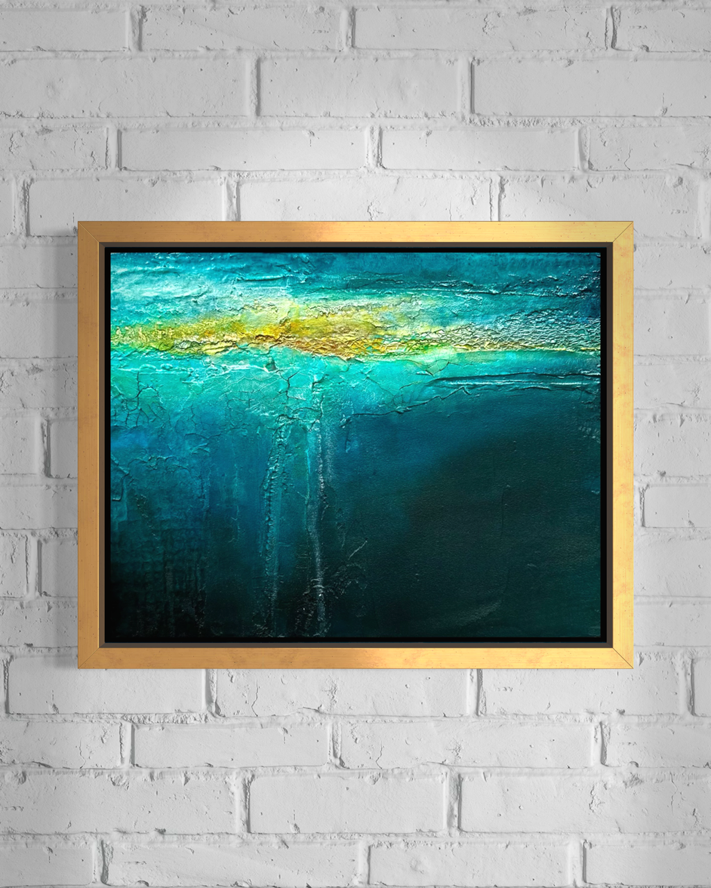 Beneath mixed media ocean abstract painting in gold frame by artist Jen Muse
