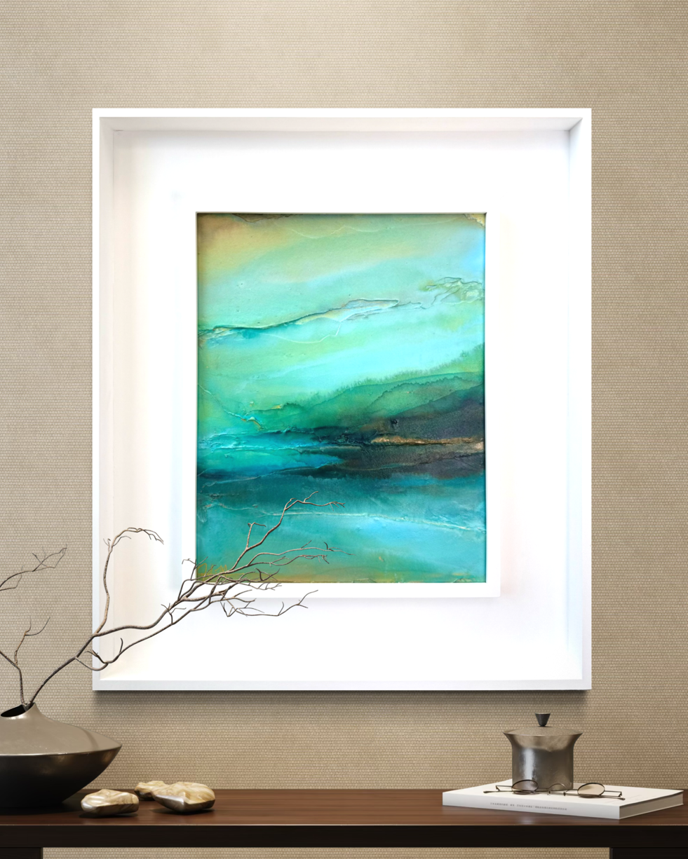 An original abstract inspired by the cenotes of Mexico framed in a white modern wood frame in a modern living room by artist Jen Muse