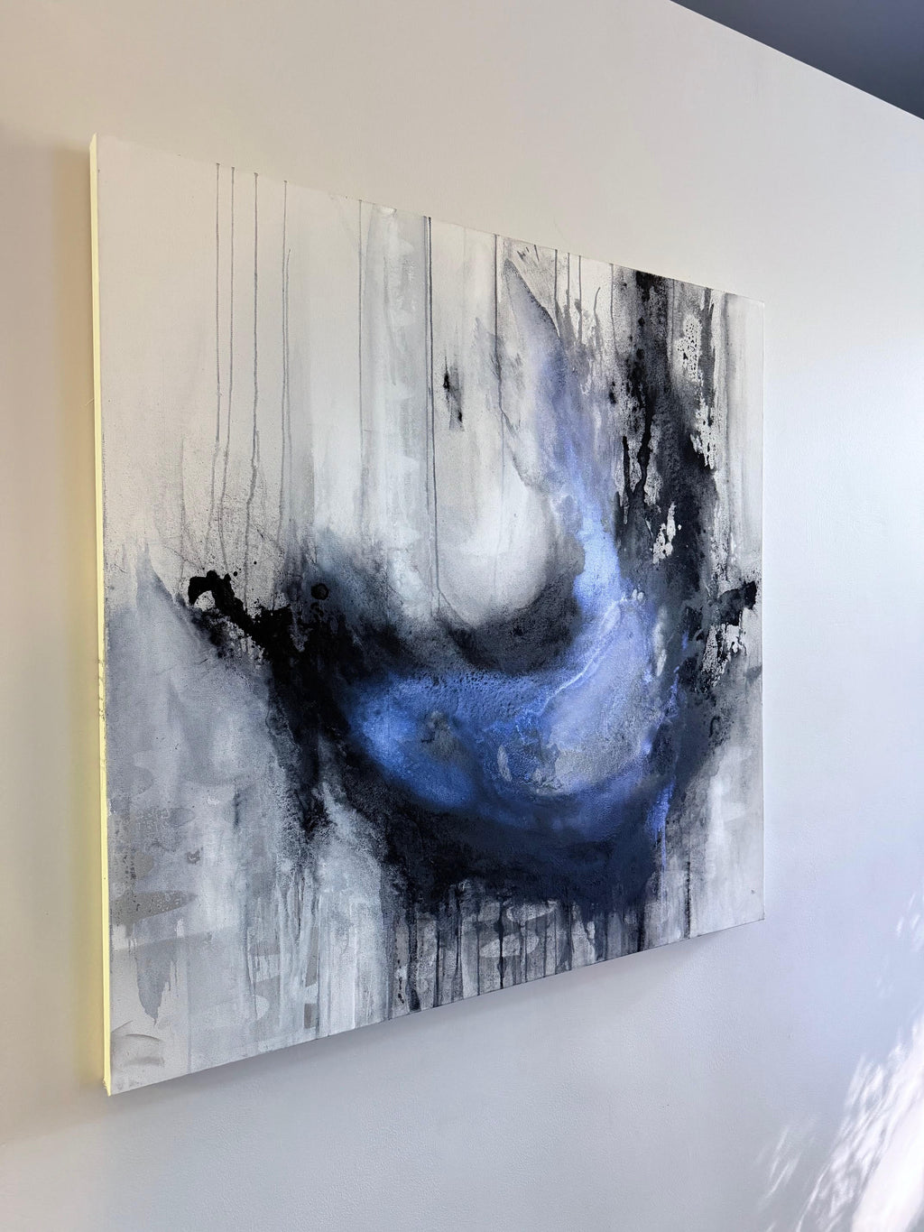 Coming Undone fluid charcoal painting on a gallery wall 