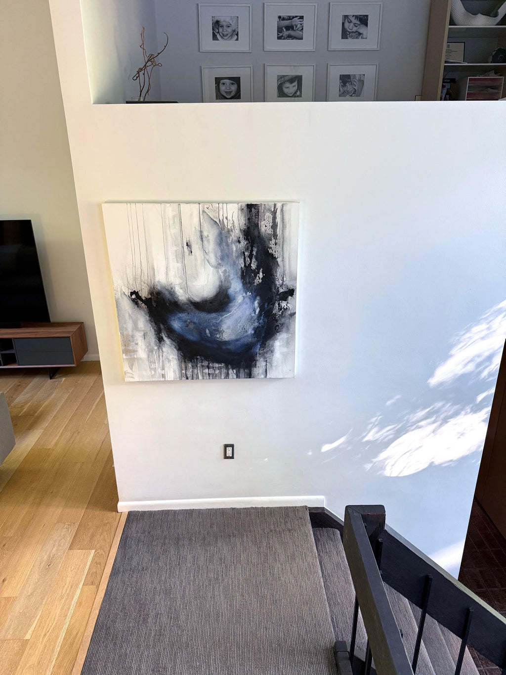 Coming Undone abstract charcoal painting in a gallery