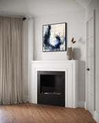 Enduring charcoal abstract painting above a fire place in a white modern living room