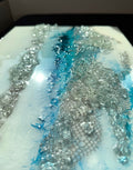 Mixed media artwork with kiln-formed recycled glass and aqua blue textures 