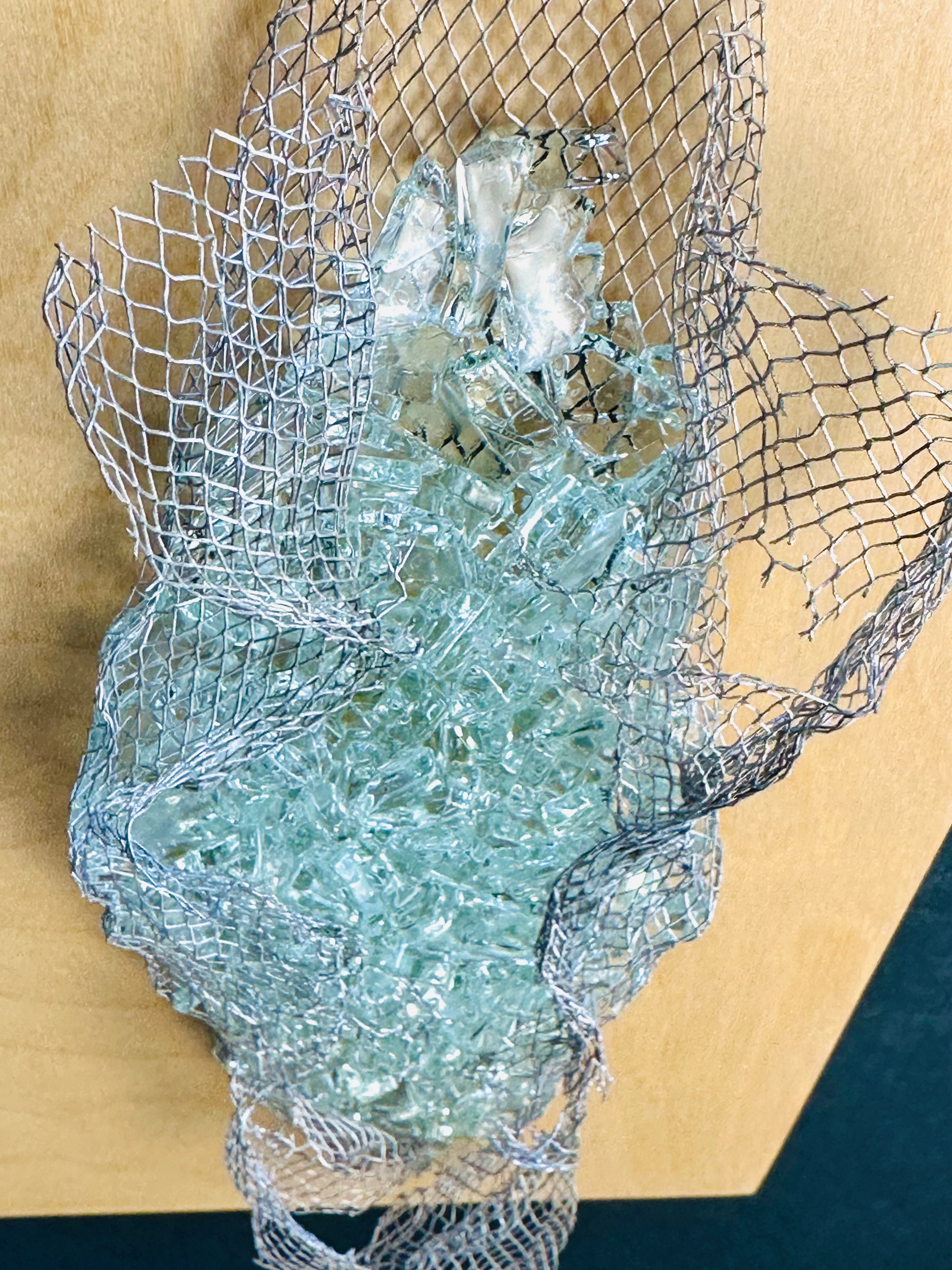 Detail2 of kiln-formed recycled glass and wire mesh texture in wall sculpture by Jen Muse
