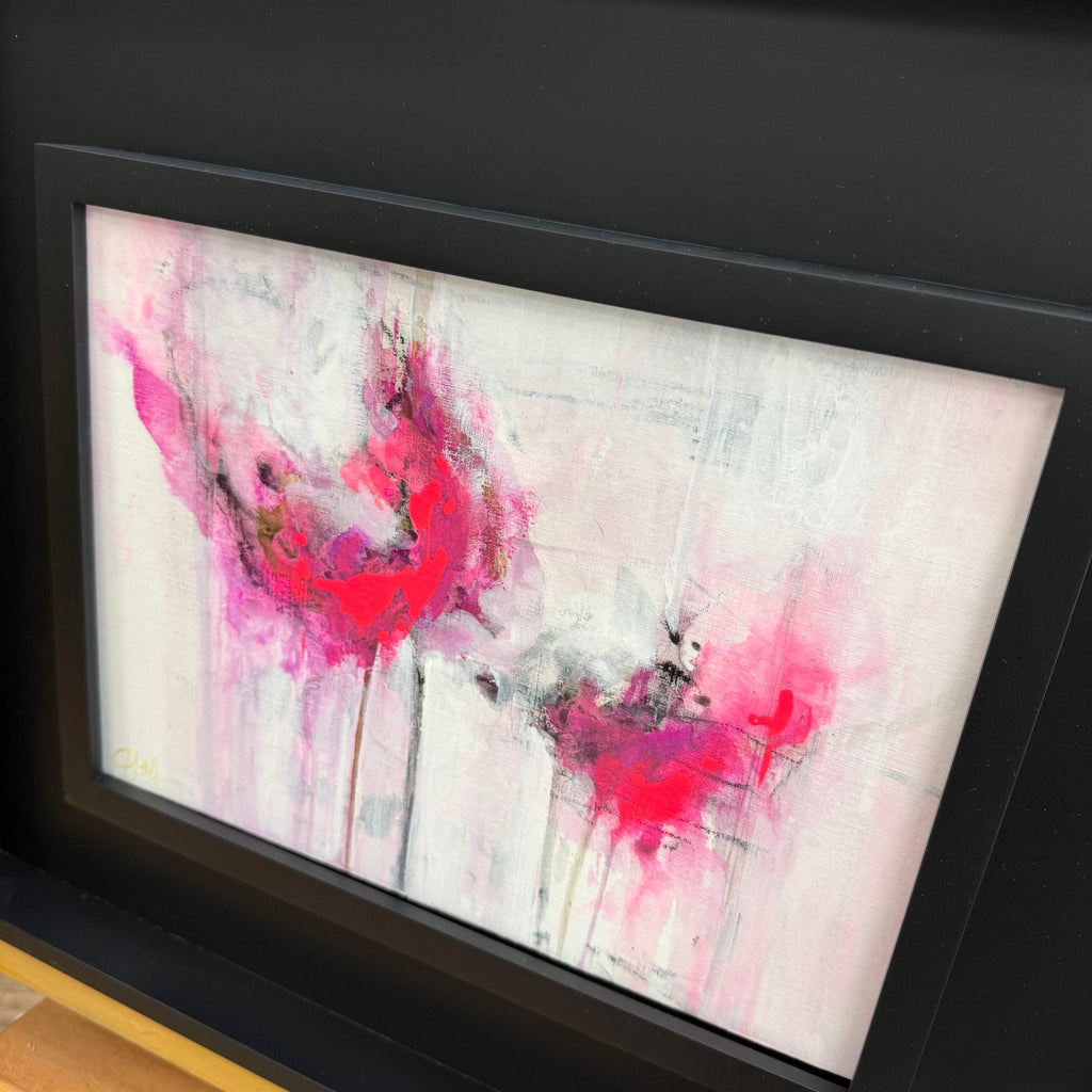 pink evanescence mini abstract study  with pink and red splashes framed in wide black modern frame