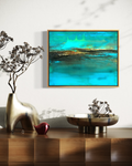 The Rush mixed media ocean abstract painting framed in gold over modern wood side table