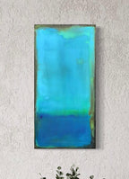 Waiting is an abstract zen acrylic painting with a gradient of blue colors on a textured white wall by artist Jen Muse